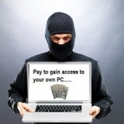 a man wearing a black mask depicting the ransomware virus